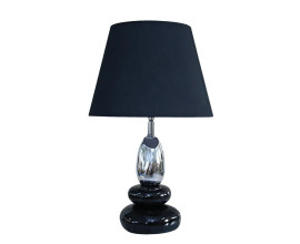 Dizajnov&aacute; glamour čierna stoln&aacute; lampa Caillou s podstavou v tvare kameňov s okr&uacute;hlym tienidlom s roz&scaron;&iacute;renou spodnou časťou s ov&aacute;lnou nohou v striebornej farbe
