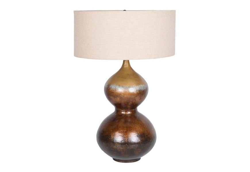 Luxusná moderná dizajnová stolná lampa Calabasas s kovovou podstavou s dvomi rozšírený bruchami s starožitným patinovaným efektom v odtieňoch hnedej a zlatej so smaltovaným povrchom s okrúhlym textilným tienidlom z ľanu v béžovej farbe