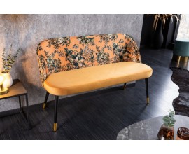 Žlt&aacute; art-deco lavica Floreque s kvetinov&yacute;m vzorom a čiernymi kovov&yacute;mi nožičkami