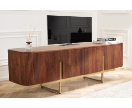 Luxusn&yacute; art deco TV stol&iacute;k Gatsby z mangoveho mas&iacute;vneho dreva s obl&yacute;mi tvarmi a obl&uacute;kovou reli&eacute;fnou v&yacute;zdobou v hnedej medovej farbe so zlat&yacute;mi nožičkami, 160 cm