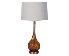 Glamour retro stoln&aacute; lampa Antari s podstavou zo skla s hned&yacute;m t&oacute;novan&iacute;m v spodnej časti s kovovou kon&scaron;trukciou v zlatej farbe s okr&uacute;hlym tienidlom z ľanu v b&eacute;žovej farbe