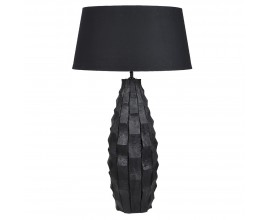 Modern&aacute; čierna stoln&aacute; lampa Coalwood s mas&iacute;vnou drevenou nohou v tvare hore z&uacute;žen&eacute;ho valca s reli&eacute;fnym vyrez&aacute;van&iacute;m a okr&uacute;hlym dole roz&scaron;&iacute;ren&yacute;m tienidlom z ľanu